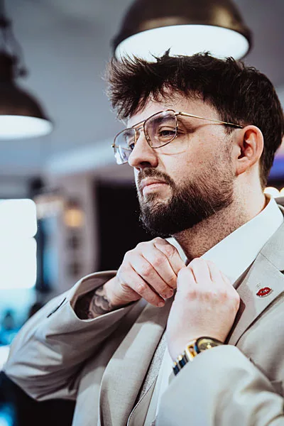 Businessportrait eines Mannes mit Brille und Bart in einem hellen Sakko.